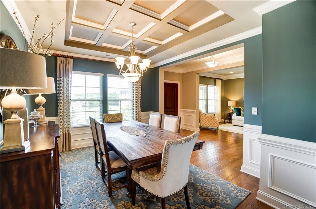 692 Old Cove Road Tega Cay, SC 29708 - Photo 6 of 44 a dining room with furniture a chandelier and wooden floor