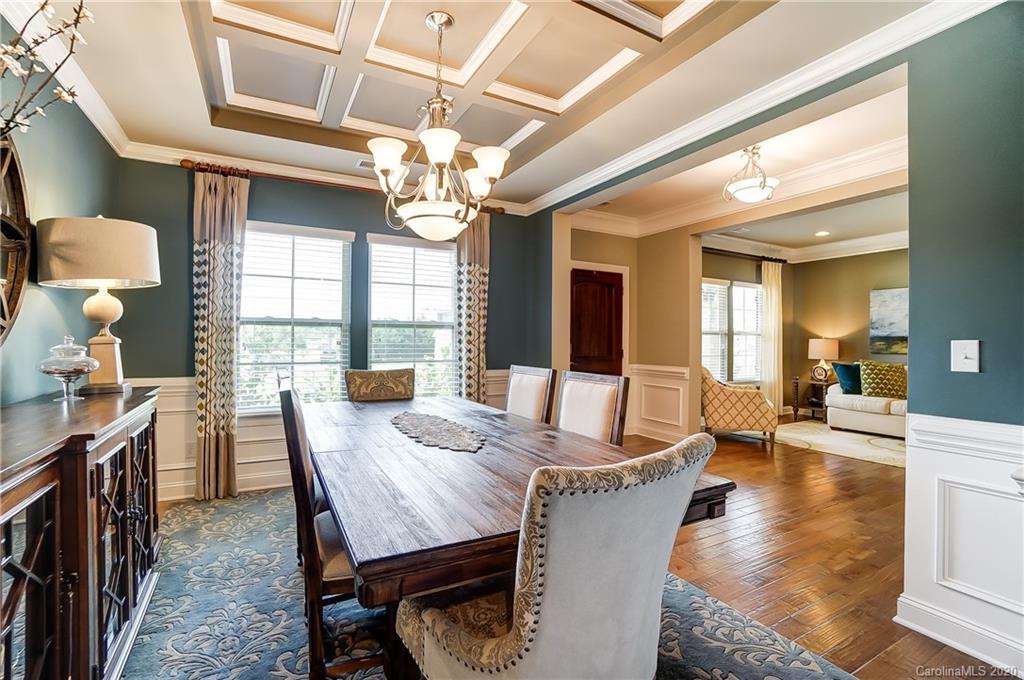 692 Old Cove Road Tega Cay, SC 29708 - Photo 7 of 44 a view of a dining room with furniture a chandelier and wooden floor