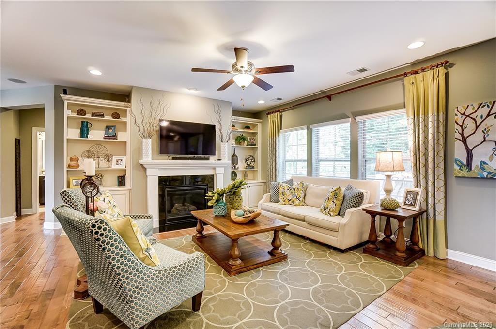 692 Old Cove Road Tega Cay, SC 29708 - Photo 9 of 44 a living room with furniture a fireplace and a flat screen tv