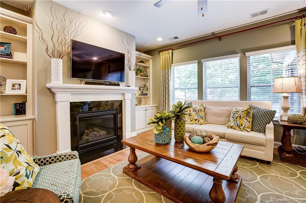 692 Old Cove Road Tega Cay, SC 29708 - Photo 10 of 44 a living room with furniture a flat screen tv and a fireplace