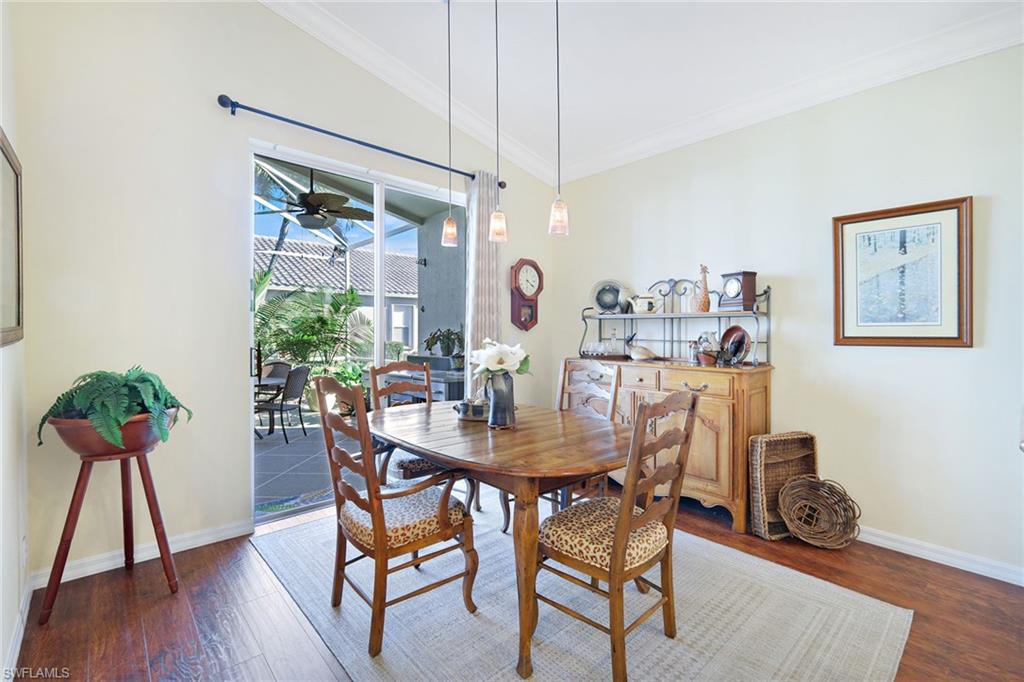 9354 Springview Loop Estero, FL 33928 - Photo 11 of 30 a view of a dining room with furniture and wooden floor