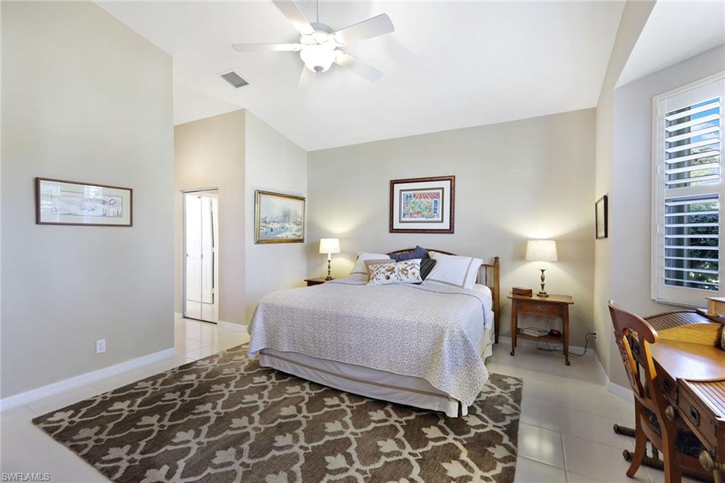 9354 Springview Loop Estero, FL 33928 - Photo 16 of 30 a bedroom with a bed lamp and a window