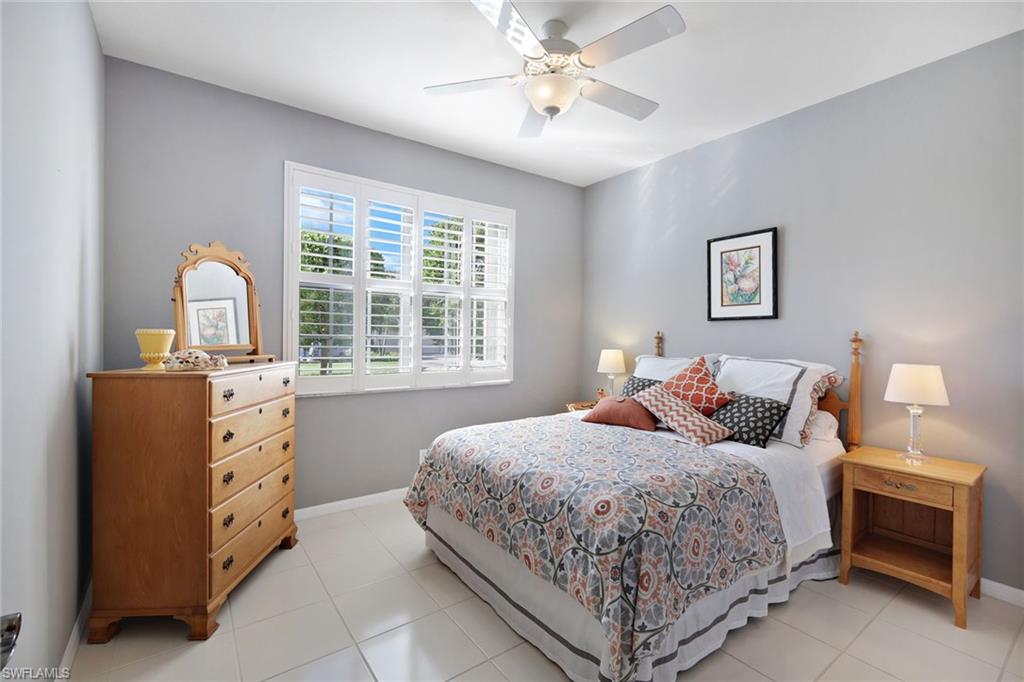 9354 Springview Loop Estero, FL 33928 - Photo 19 of 30 a bedroom with a bed and a chandelier