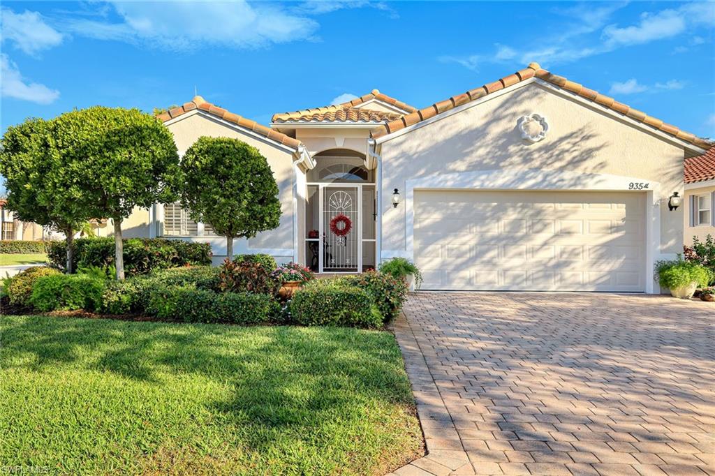 9354 Springview Loop Estero, FL 33928 - Photo 25 of 30 a front view of a house with garden