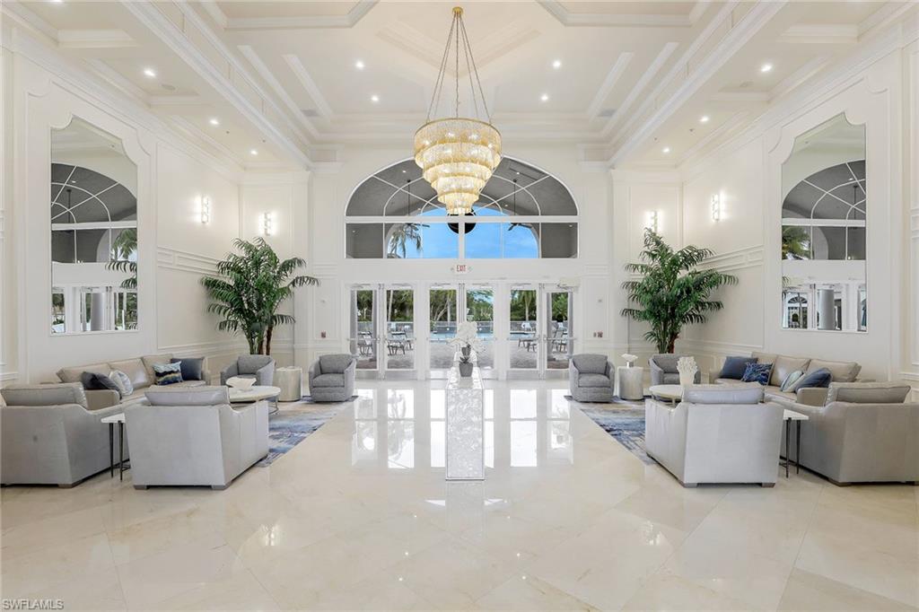 9354 Springview Loop Estero, FL 33928 - Photo 27 of 30 a living room with furniture a chandelier and a fireplace