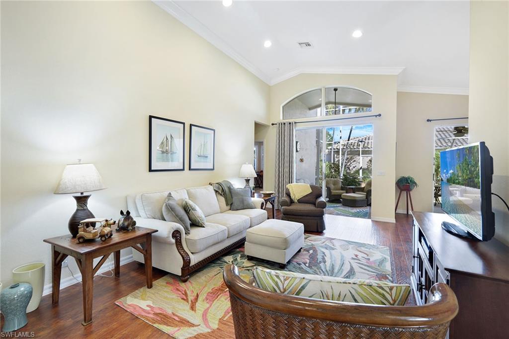 9354 Springview Loop Estero, FL 33928 - Photo 6 of 30 a living room with furniture and a chandelier