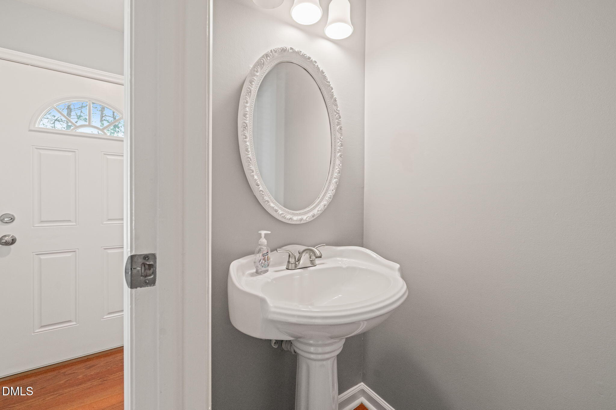 7739 Ohmann Court Raleigh, NC 27615 - Photo 14 of 38 a bathroom with a sink and a mirror