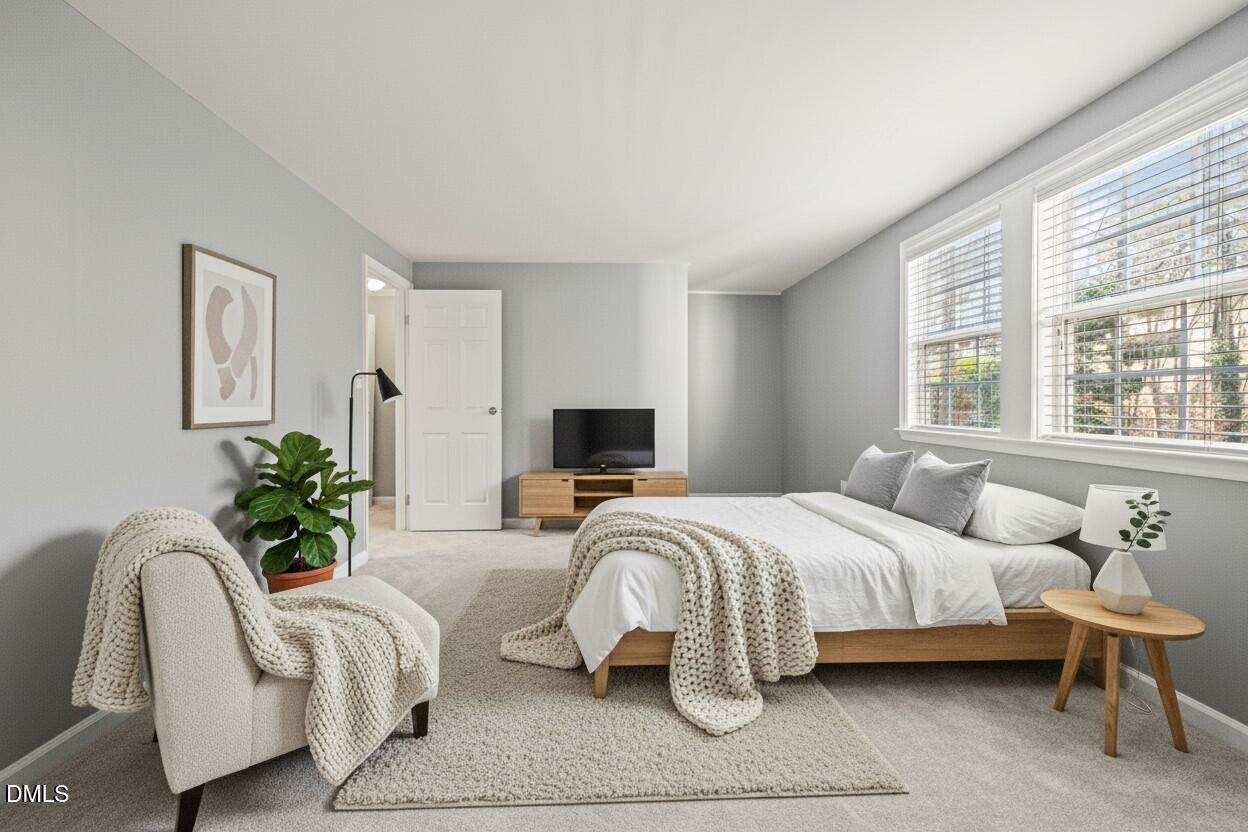 7739 Ohmann Court Raleigh, NC 27615 - Photo 15 of 38 a bedroom with bed and a large window