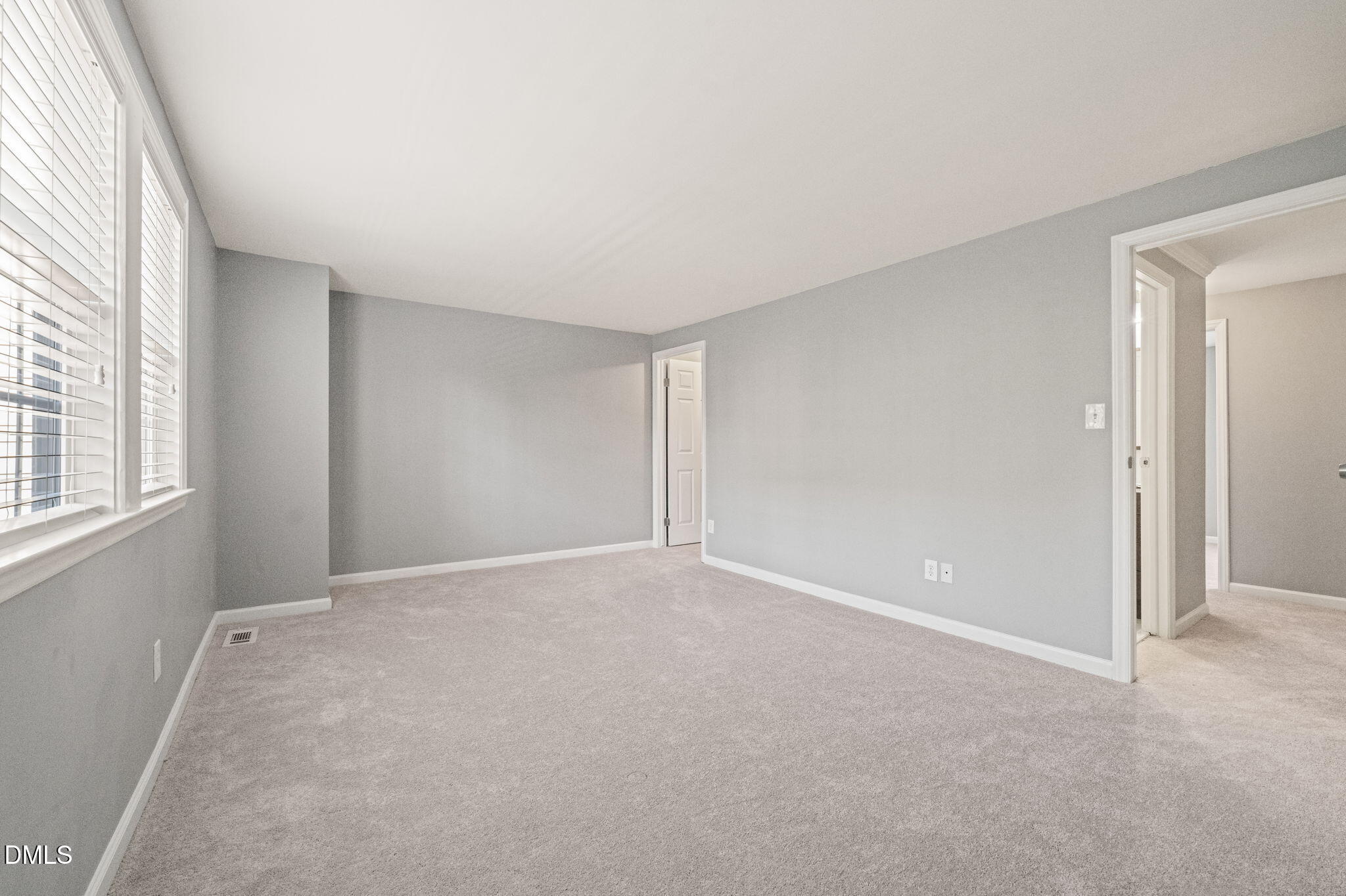 7739 Ohmann Court Raleigh, NC 27615 - Photo 18 of 38 an empty room with windows and closet