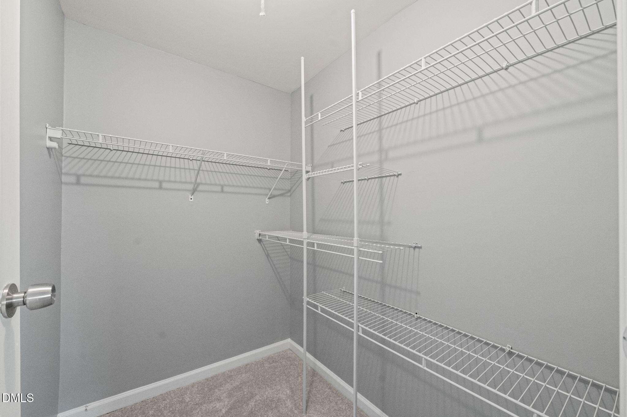 7739 Ohmann Court Raleigh, NC 27615 - Photo 19 of 38 a view of a room with racks on the wall