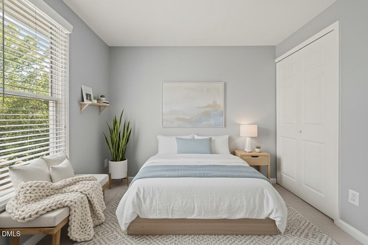 7739 Ohmann Court Raleigh, NC 27615 - Photo 21 of 38 a bedroom with a bed and window
