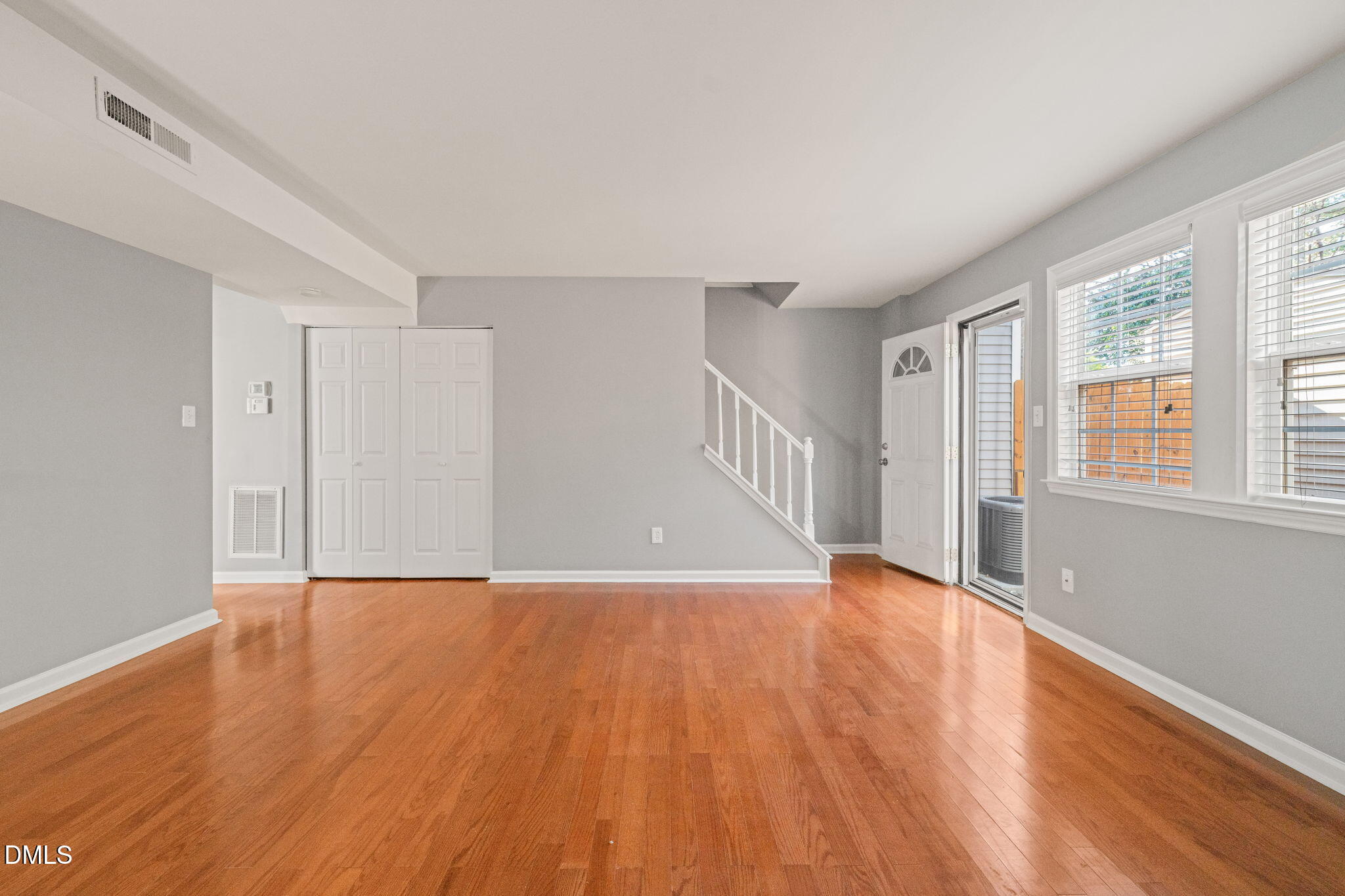 7739 Ohmann Court Raleigh, NC 27615 - Photo 3 of 38 a view of an empty room with wooden floor and a window