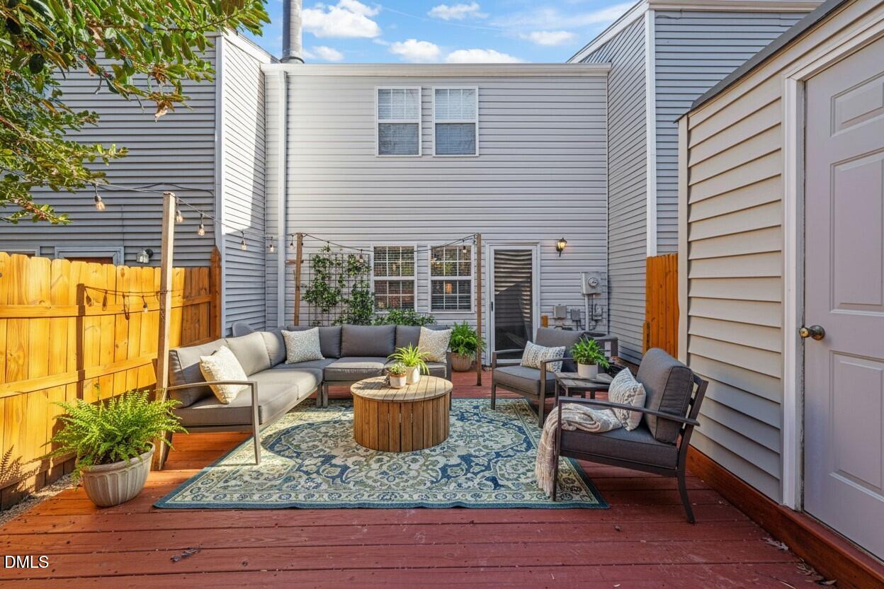 7739 Ohmann Court Raleigh, NC 27615 - Photo 33 of 38 a view of a patio with couches chairs potted plants and wooden floor