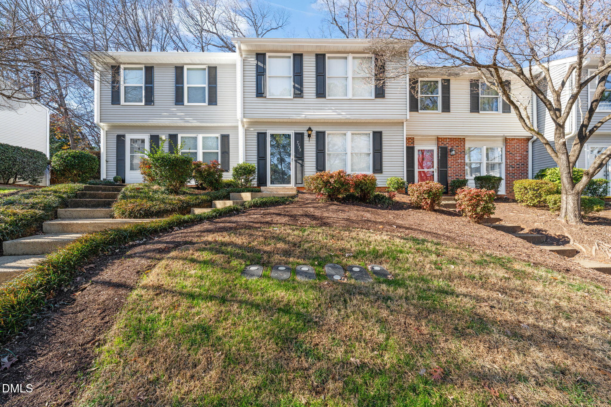 7739 Ohmann Court Raleigh, NC 27615 - Photo 35 of 38 a view of a yard in front of a brick house