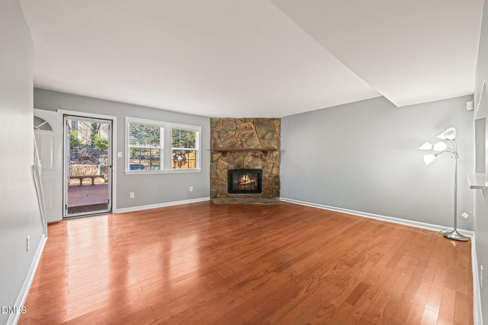 7739 Ohmann Court Raleigh, NC 27615 - Photo 4 of 38 wooden floor in an empty room with a fireplace
