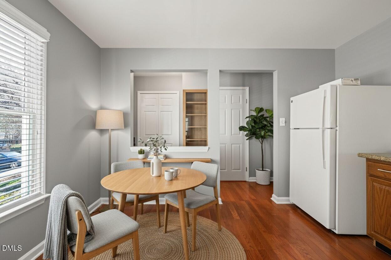 7739 Ohmann Court Raleigh, NC 27615 - Photo 7 of 38 a view of a dining room with furniture window and wooden floor