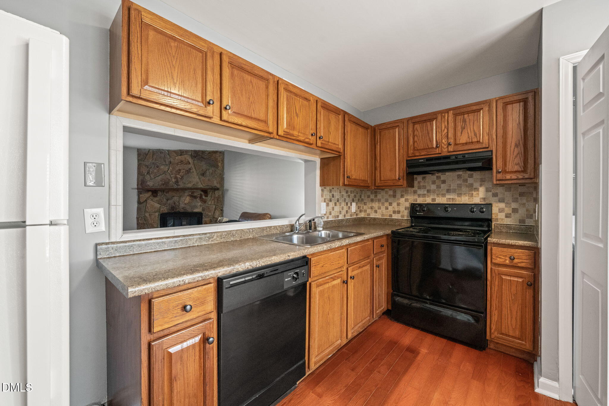 7739 Ohmann Court Raleigh, NC 27615 - Photo 9 of 38 a kitchen with granite countertop a stove and a sink