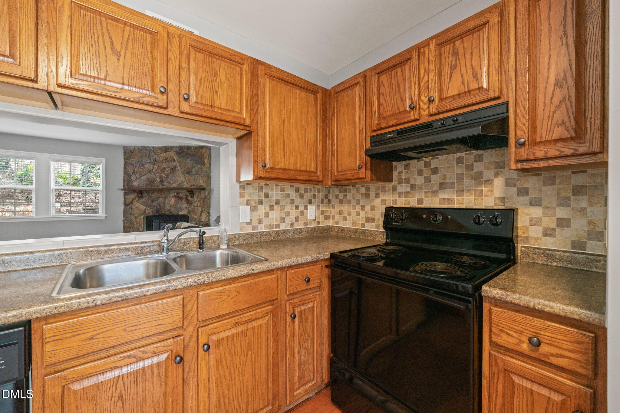7739 Ohmann Court Raleigh, NC 27615 - Photo 10 of 38 a kitchen with granite countertop cabinets stainless steel appliances a stove and a sink