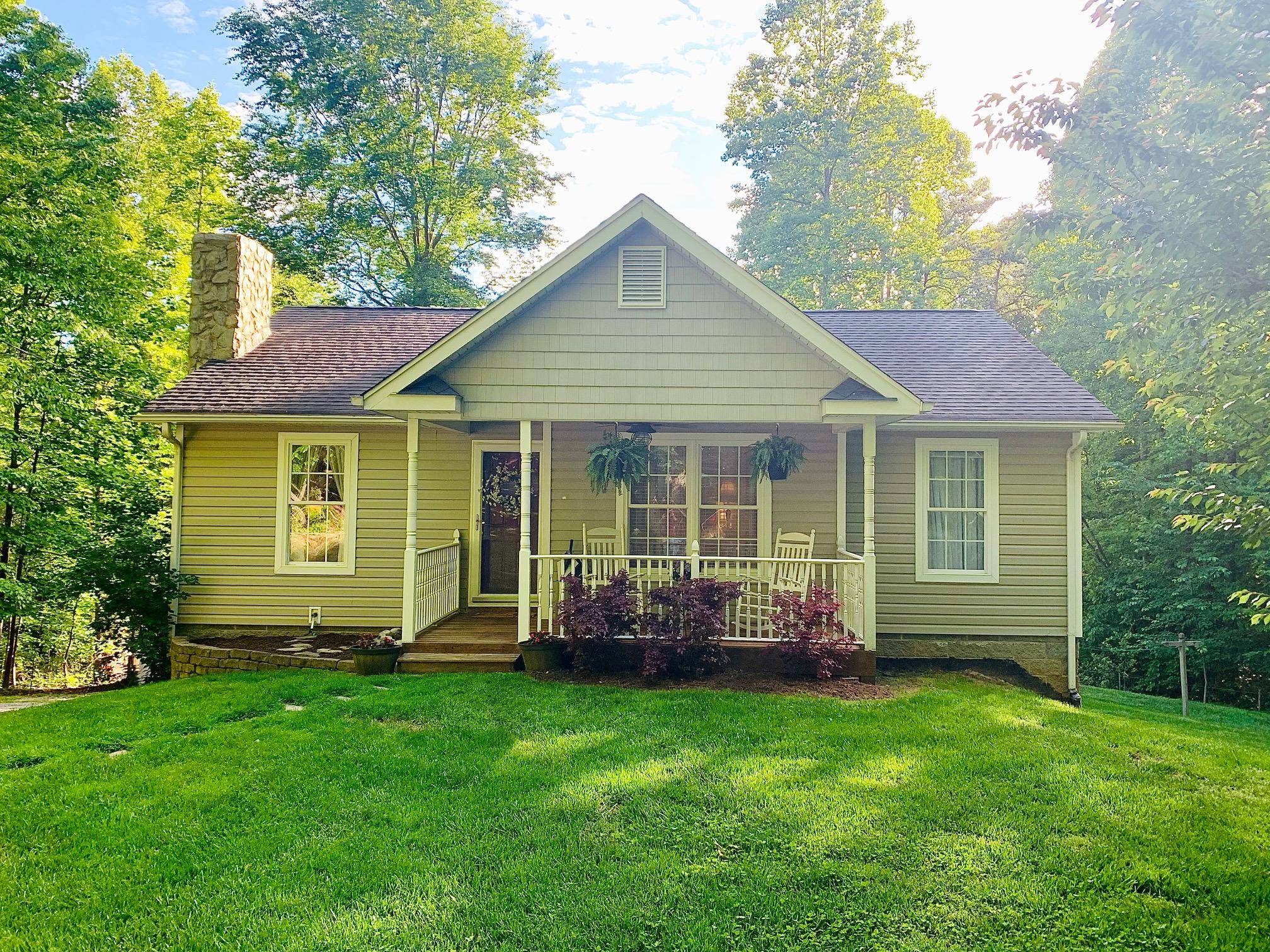 a view of a house with a yard and a garden