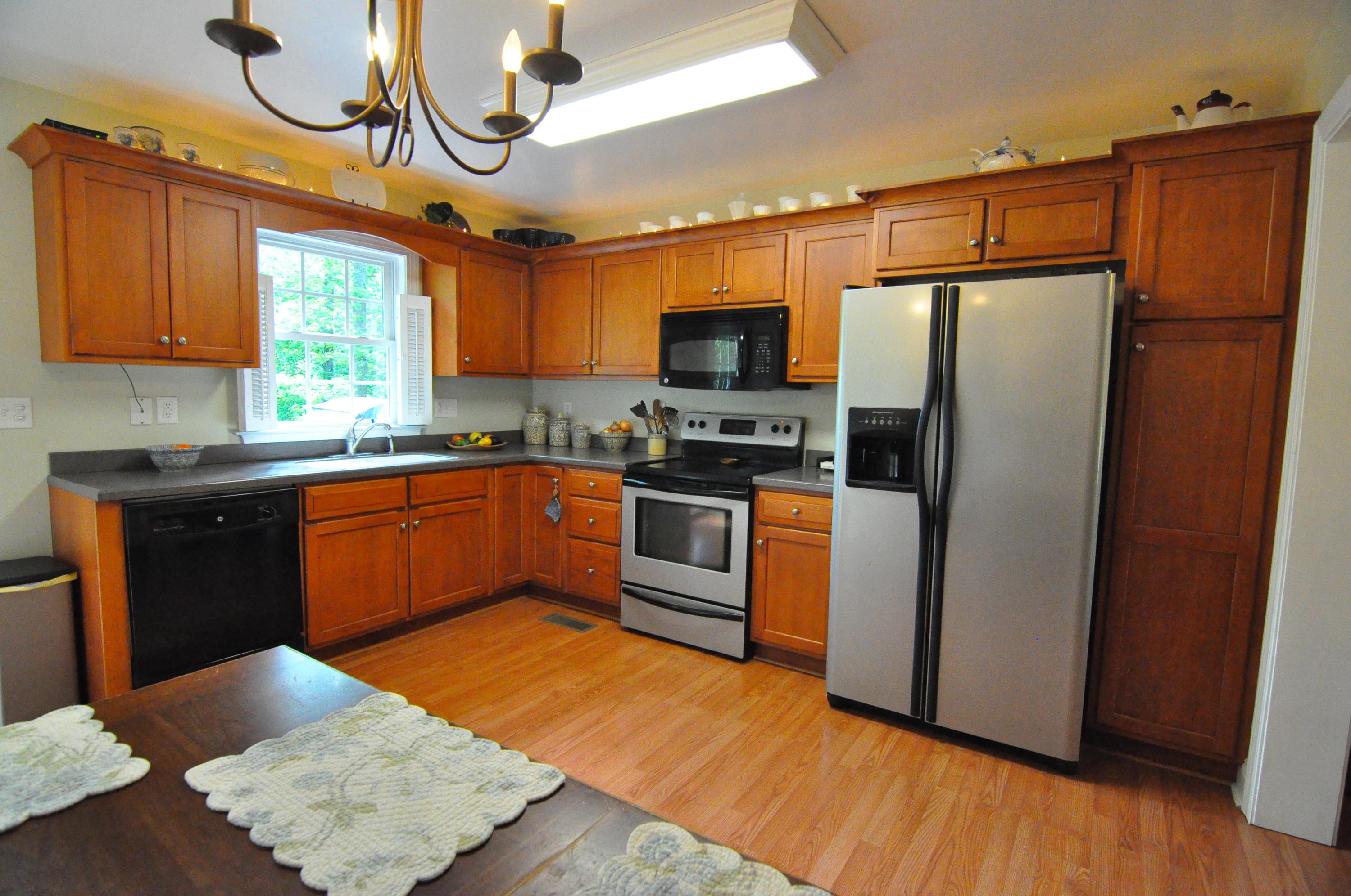 832 Old Henry Road Henry, VA 24102 - Photo 11 of 30 a kitchen with stainless steel appliances granite countertop a sink a stove a refrigerator and cabinets