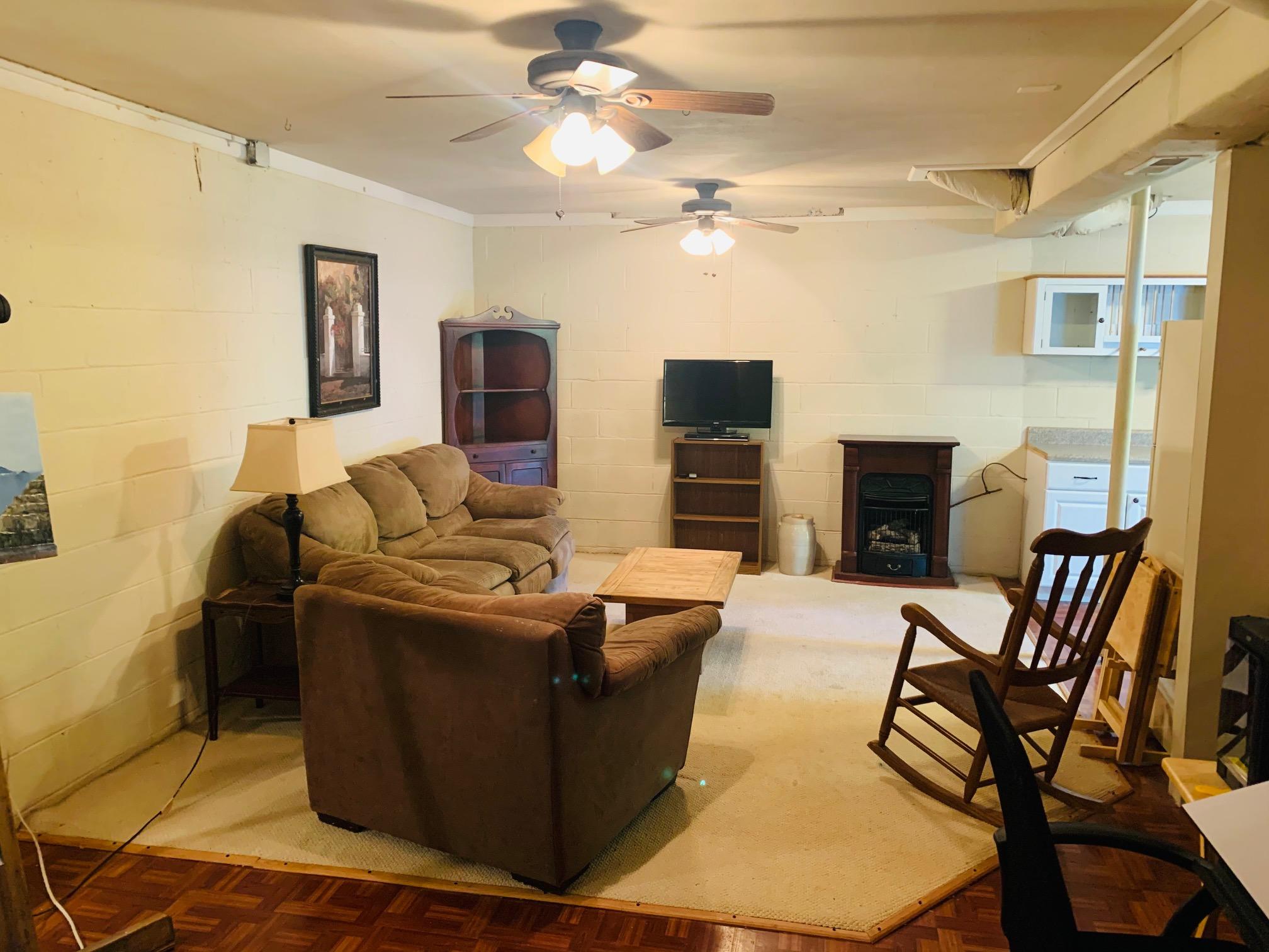 832 Old Henry Road Henry, VA 24102 - Photo 21 of 30 a living room with furniture a fireplace and a flat screen tv