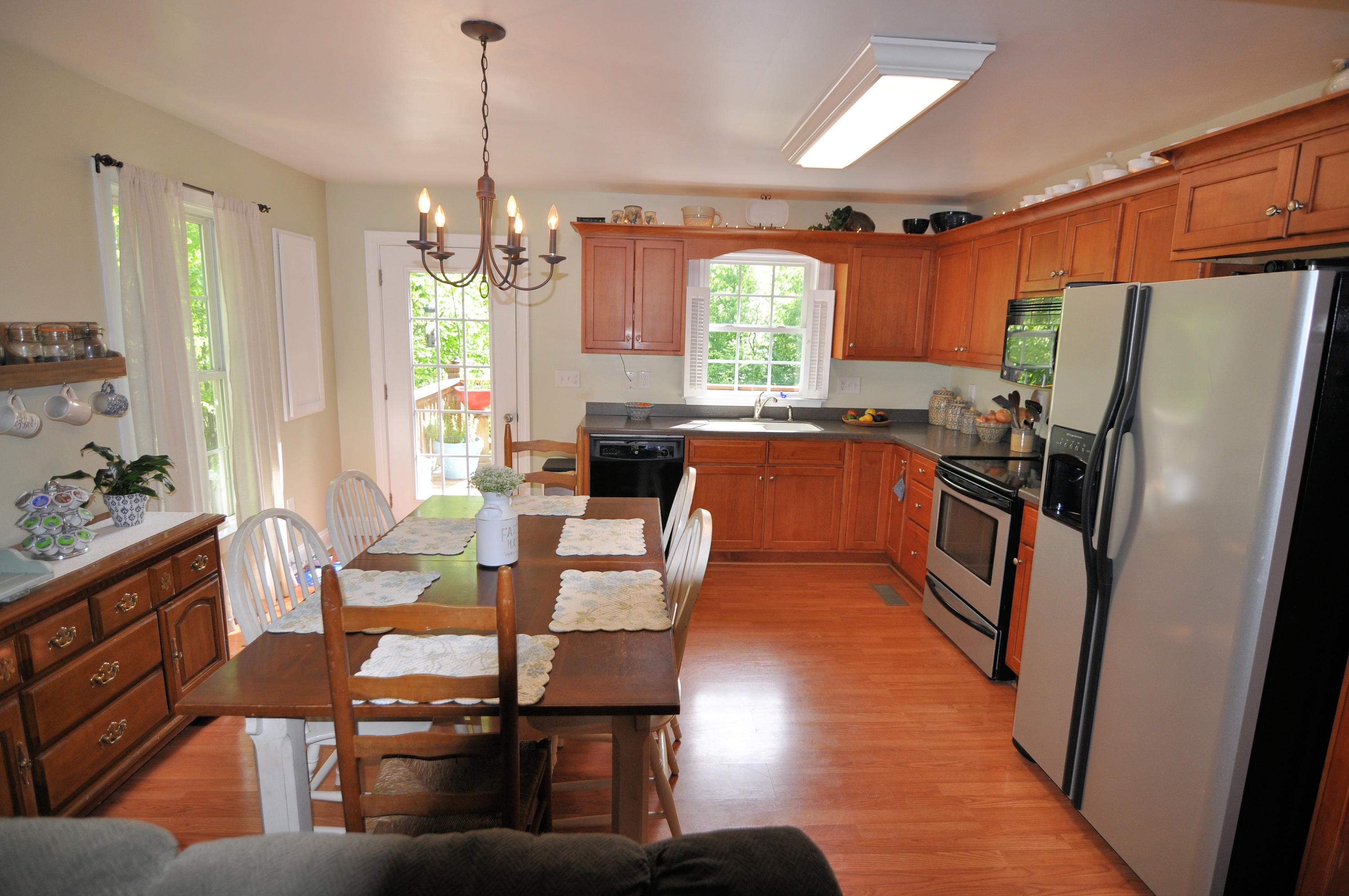 832 Old Henry Road Henry, VA 24102 - Photo 9 of 30 a dining room with furniture a chandelier and wooden floor