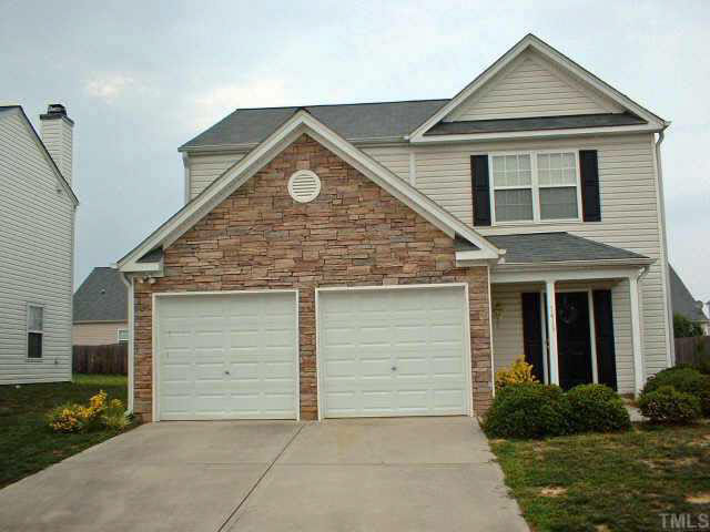 7413 Lowell Ridge Road Raleigh, NC 27616 - Photo 1 of 10 a front view of a house with a garden