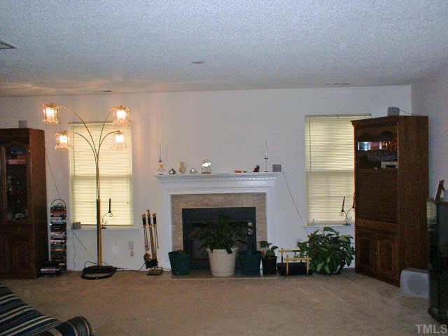 7413 Lowell Ridge Road Raleigh, NC 27616 - Photo 2 of 10 a living room with furniture and a fireplace