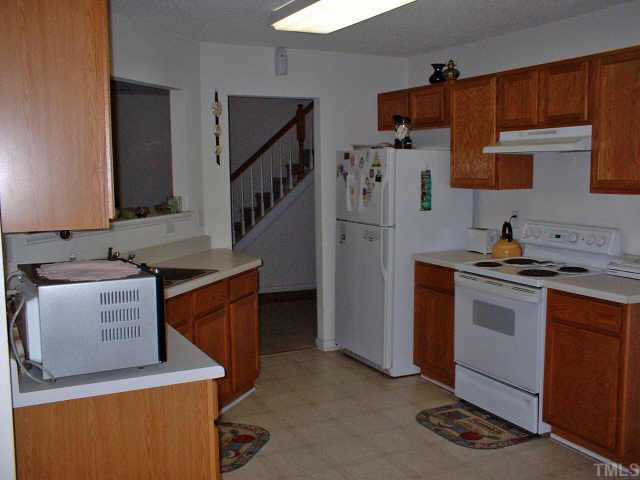 7413 Lowell Ridge Road Raleigh, NC 27616 - Photo 4 of 10 a kitchen with appliances a sink and cabinets