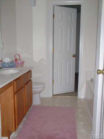7413 Lowell Ridge Road Raleigh, NC 27616 - Photo 8 of 10 a bathroom with a sink a toilet and shower
