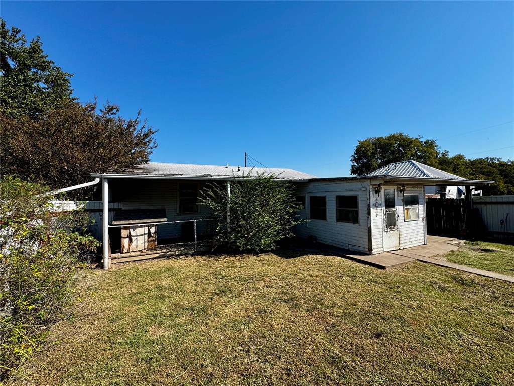 413 East Locust Street Whitewright, TX 75491 - Photo 15 of 16 Rear view of house with a metal roof
