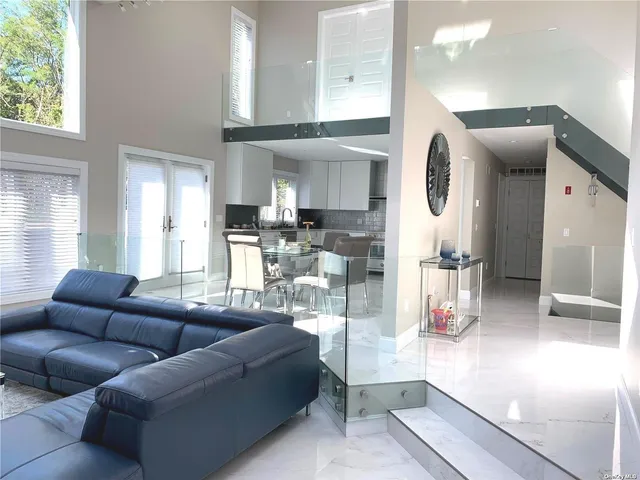 a living room with furniture and a view of kitchen