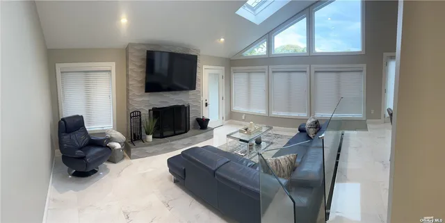 a living room with furniture flat screen tv and a fireplace