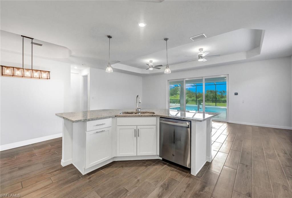 43240 Boardwalk Loop Punta Gorda, FL 33982 - Photo 11 of 41 a kitchen with stainless steel appliances granite countertop a stove and a large window