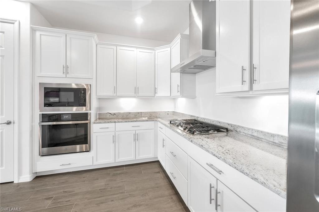43240 Boardwalk Loop Punta Gorda, FL 33982 - Photo 12 of 41 a kitchen with granite countertop white cabinets and white appliances