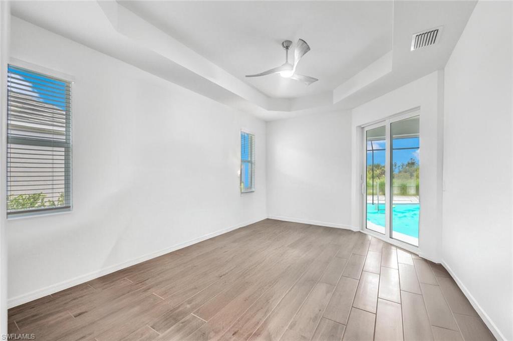 43240 Boardwalk Loop Punta Gorda, FL 33982 - Photo 17 of 41 an empty room with wooden floor and windows