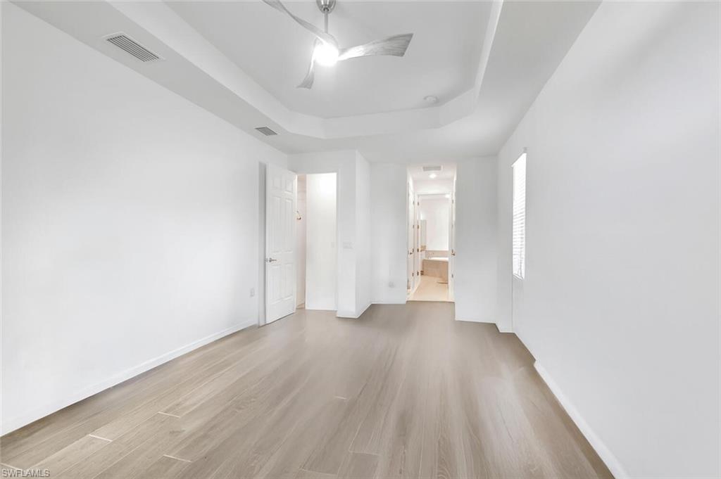 43240 Boardwalk Loop Punta Gorda, FL 33982 - Photo 20 of 41 an empty room with wooden floor and windows