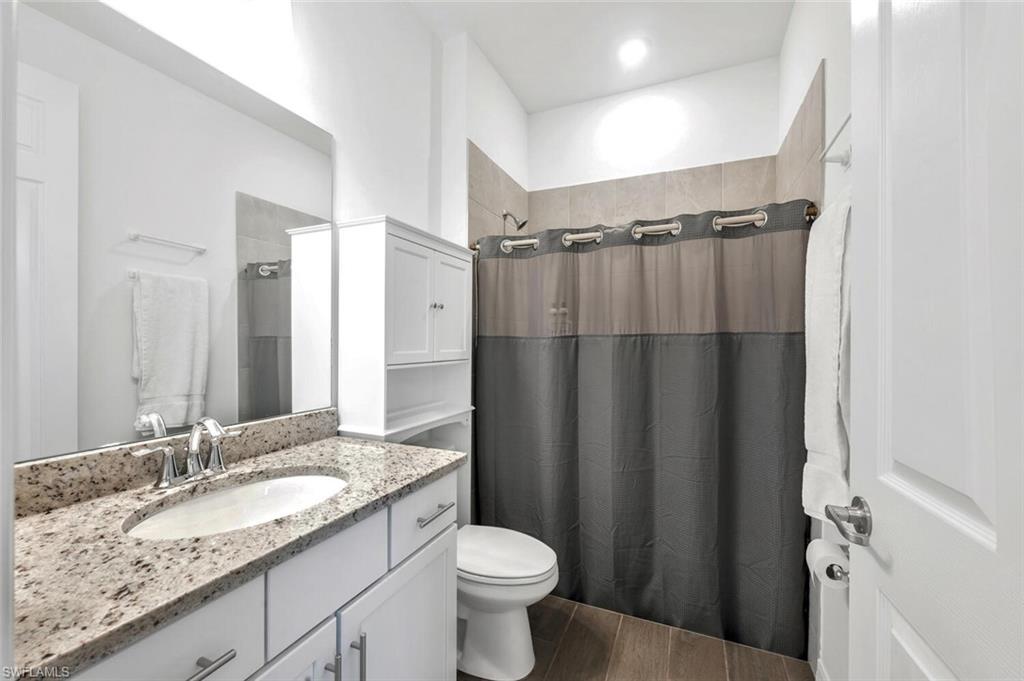 43240 Boardwalk Loop Punta Gorda, FL 33982 - Photo 21 of 41 a bathroom with a granite countertop sink toilet and shower