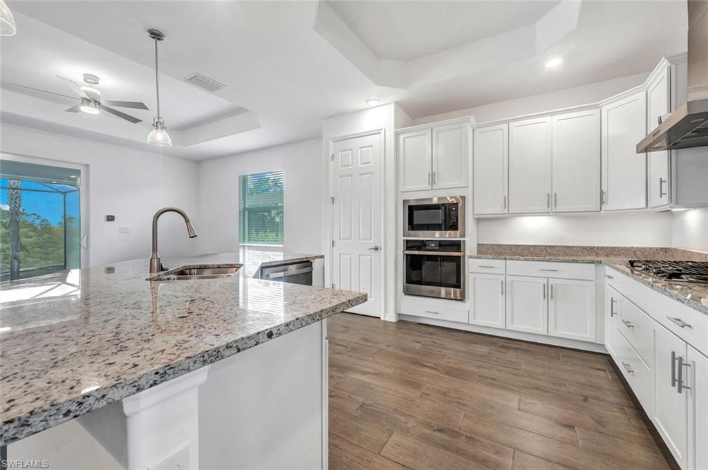43240 Boardwalk Loop Punta Gorda, FL 33982 - Photo 4 of 41 a kitchen with stainless steel appliances granite countertop a stove sink and cabinets