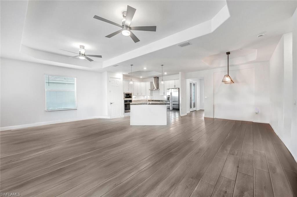 43240 Boardwalk Loop Punta Gorda, FL 33982 - Photo 8 of 41 a view of a kitchen with a dishwasher kitchen stove a refrigerator and wooden floor