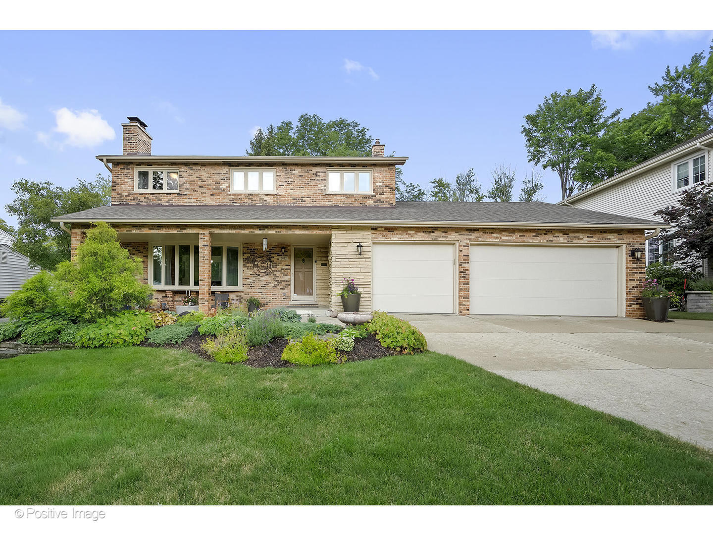 3672 Venard Road Downers Grove, IL 60515 - Photo 1 of 44 a front view of a house with a garden and plants