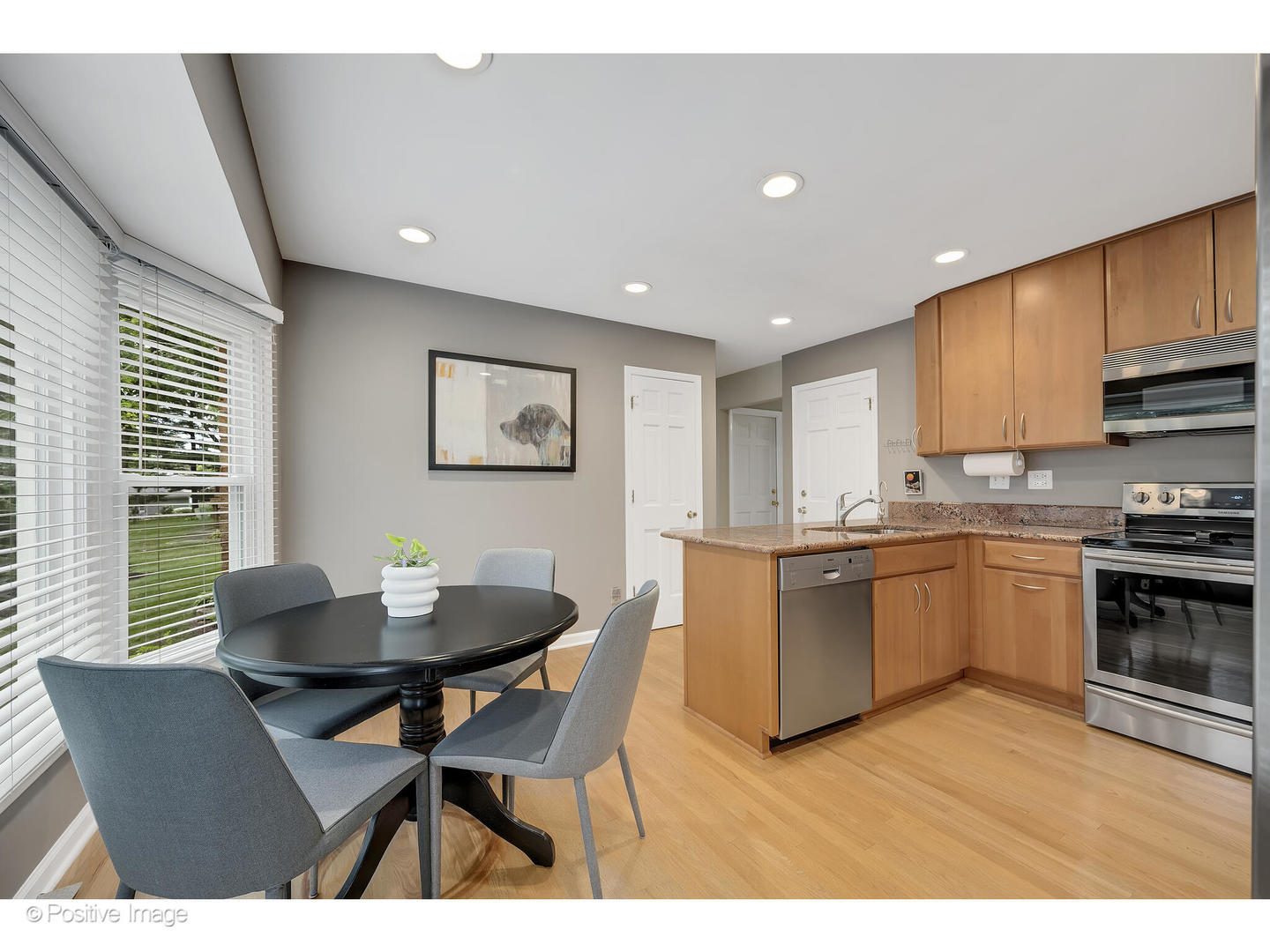3672 Venard Road Downers Grove, IL 60515 - Photo 14 of 44 a kitchen with a dining table chairs and stove