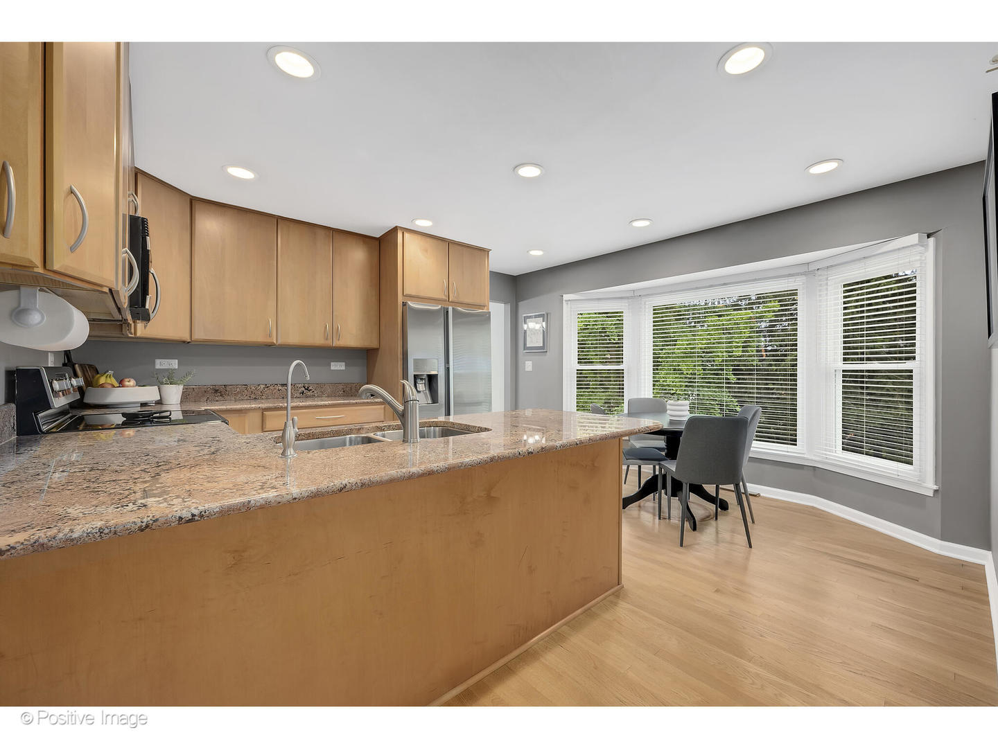 3672 Venard Road Downers Grove, IL 60515 - Photo 10 of 44 a kitchen with stainless steel appliances granite countertop sink stove and wooden cabinets