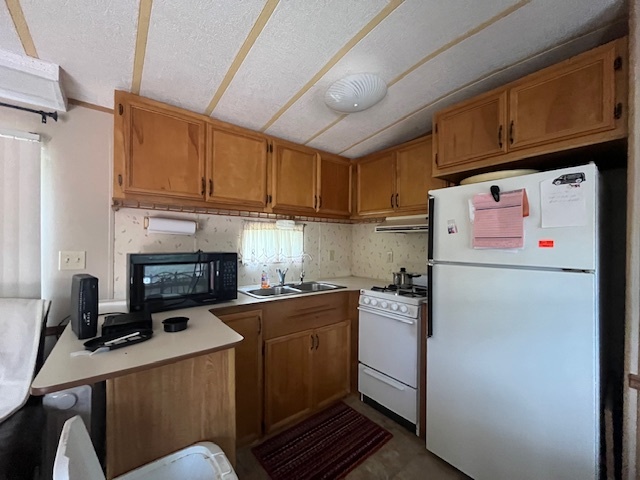 2795 East 28th Road Marseilles, IL 61341 - Photo 12 of 68 a kitchen with a refrigerator a stove a sink dishwasher and cabinets with wooden floor