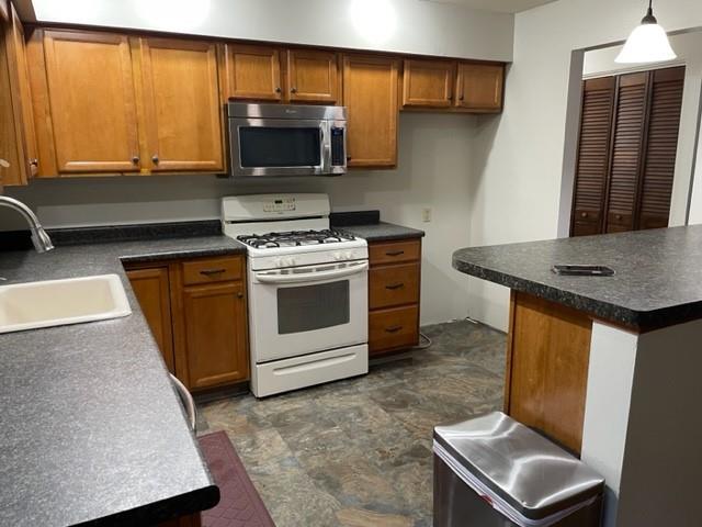 113 Louis Drive McKees Rocks, PA 15136 - Photo 7 of 25 a kitchen with stainless steel appliances a stove a sink and a microwave