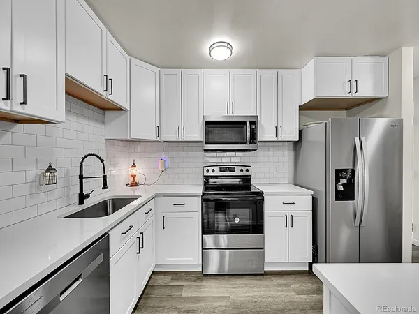 a kitchen with a sink a stove and refrigerator