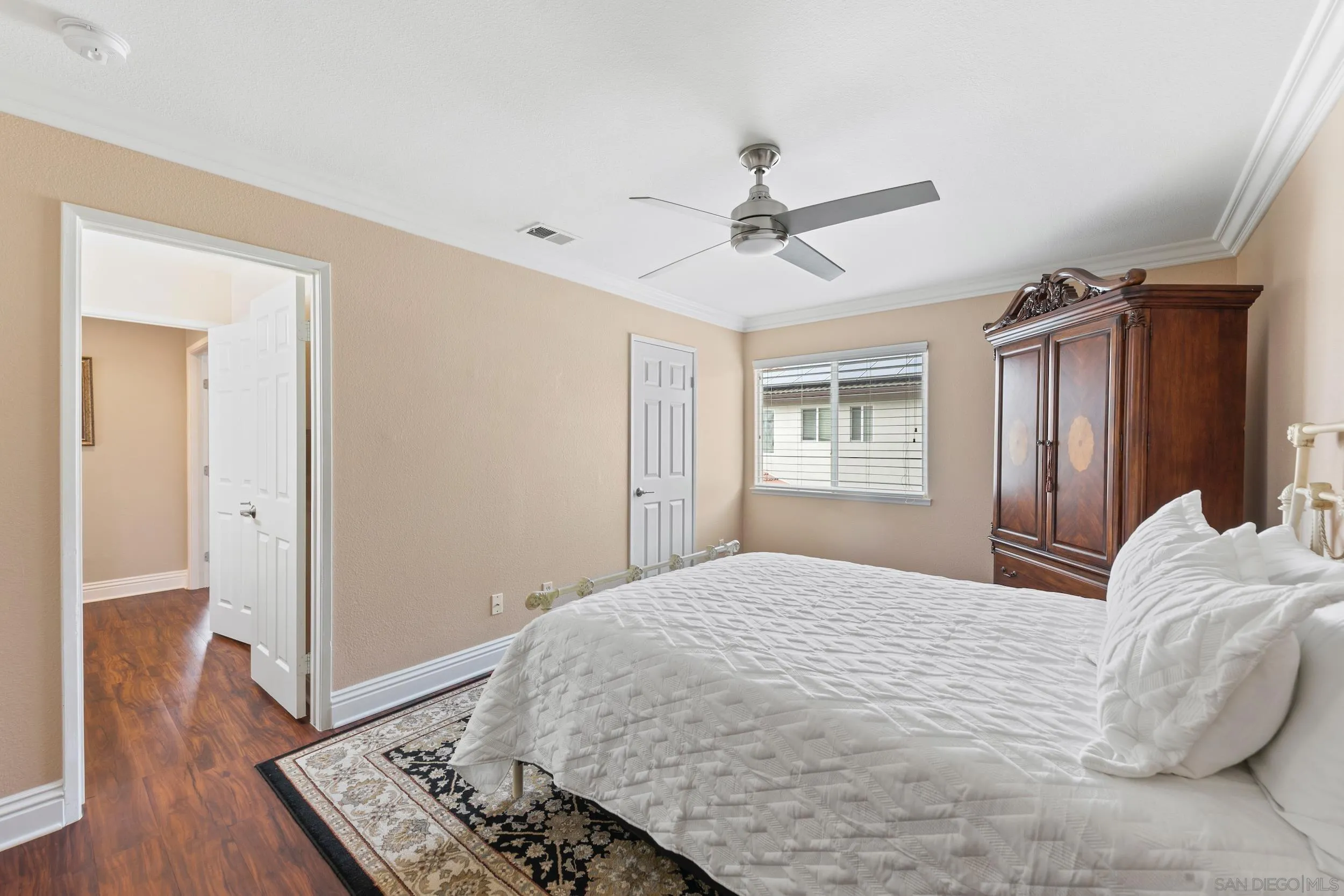 35920 Devonshire Lane Wildomar, CA 92595 - Photo 35 of 50 a bedroom with a bed and wooden floor