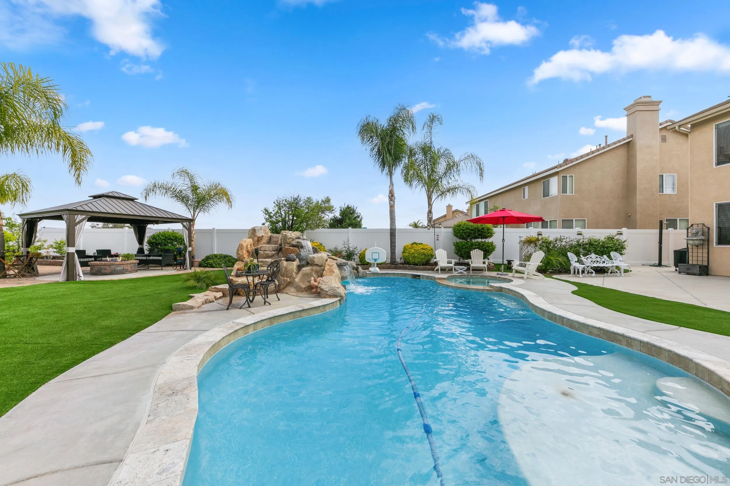 35920 Devonshire Lane Wildomar, CA 92595 - Photo 46 of 50 a view of a patio with table and chairs potted plants and palm tree