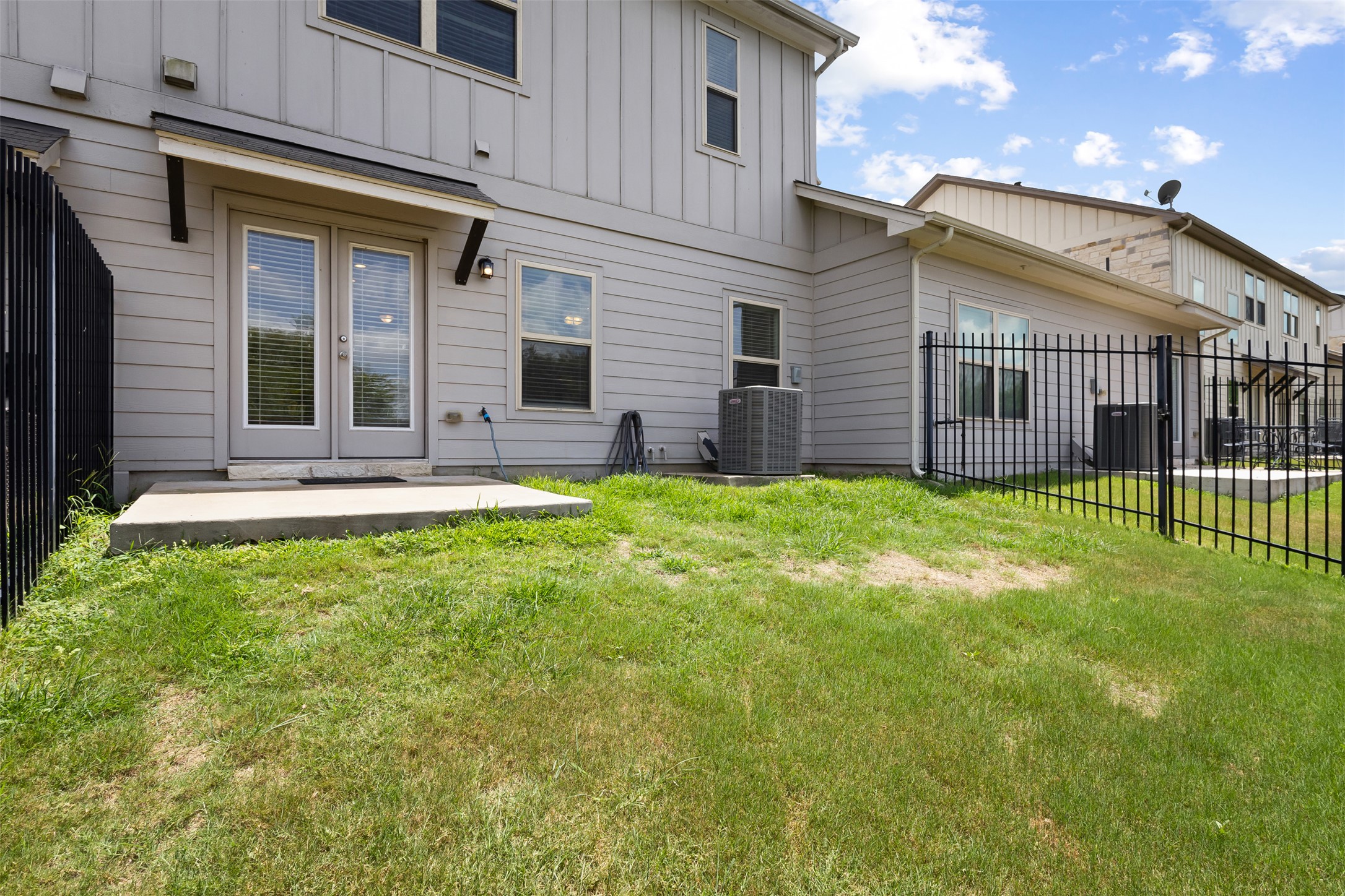1510 Catalan Road, Unit 602 Austin, TX 78748 - Photo 33 of 36 Rear view of house featuring board and batten siding and a patio area