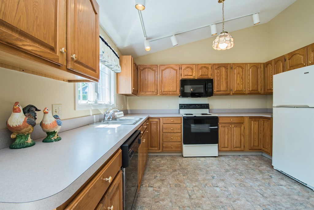 6 Chandler Way, Unit 6 Northborough, MA 01532 - Photo 17 of 37 a kitchen with stainless steel appliances granite countertop a sink a stove and a refrigerator
